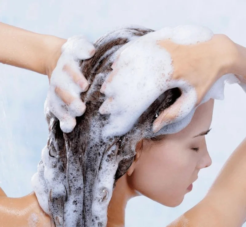 Image of a girl using hair product of grow and glow